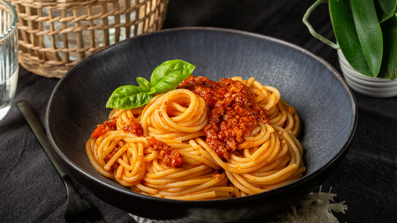 Black bowl of spaghetti Bolognese