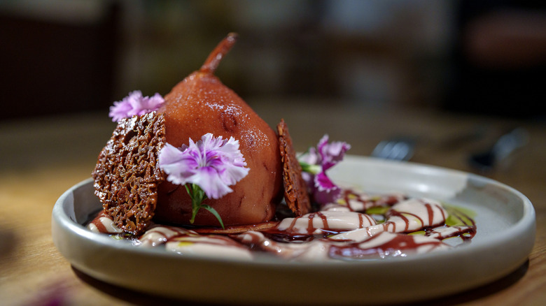 Poached pears and wine syrup with tuille