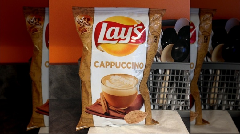 bag of Cappuccino Lay's potato chips on counter next to rack of silverware