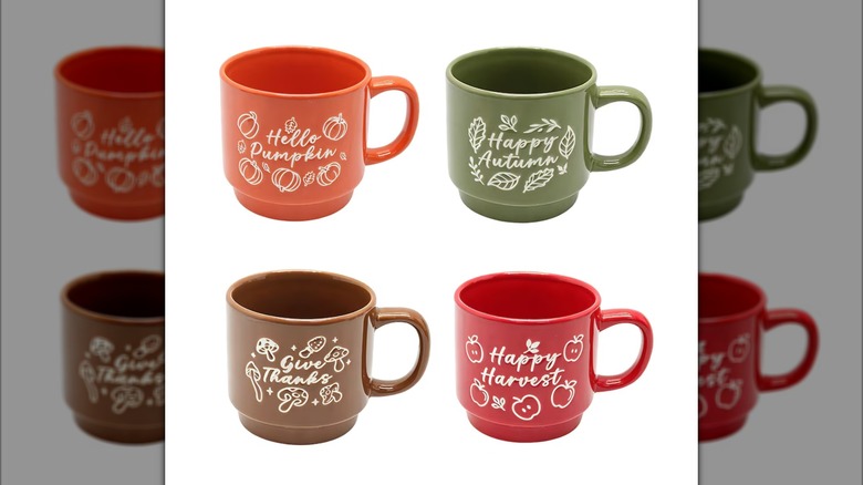 Assorted fall themed coffee mugs.