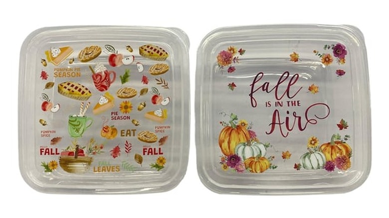 Two plastic containers with lids featuring fall designs.