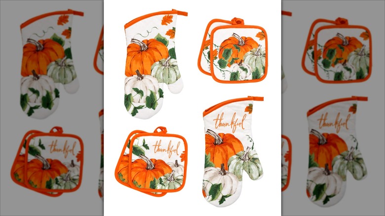 Assorted fall themed oven mitts and pot holders.