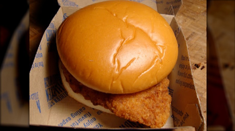 McDonald's Southern Style Chicken Sandwich on top of brown box packaging with blue writing.