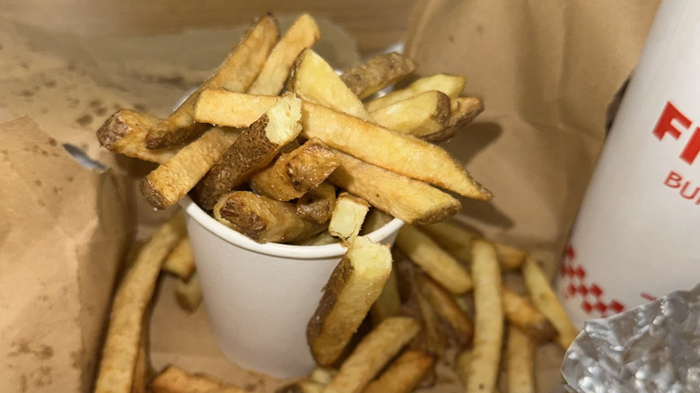 Bag of Five Guys fries with a cup