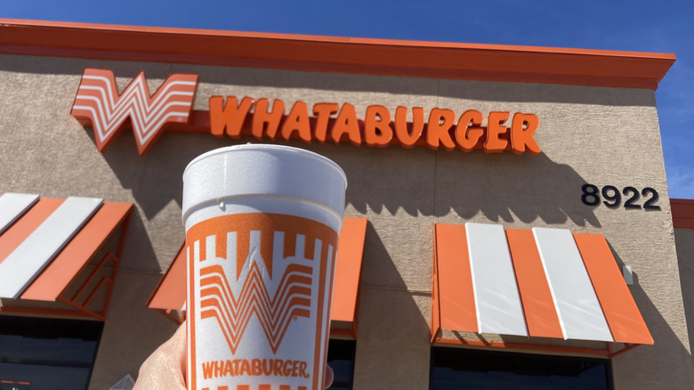 Whataburger Coke cup beneath the orange sign