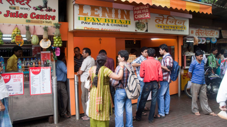 People queuing for street food vendors in Mumbai