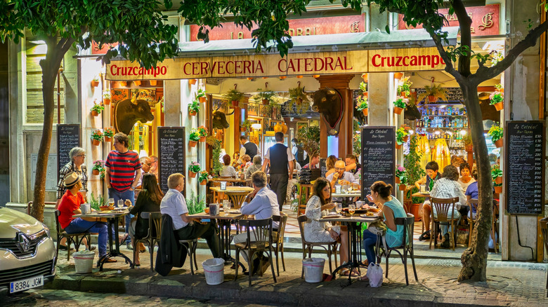 Outdoor diners at restaurant in Seville, Spain