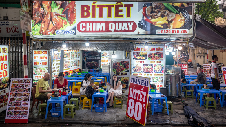 Diners outside restaurant in Vietnam