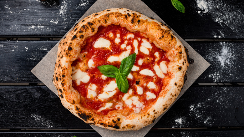 Neapolitan pizza on rustic wooden table