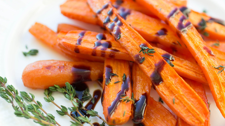 Balsamic glaze drizzles over carrots