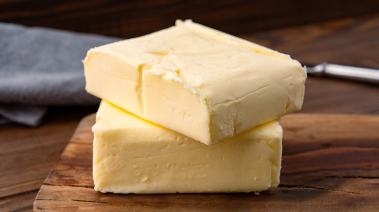 Sticks of butter on wooden board