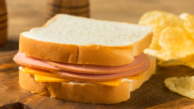 Bologna and cheese on white with chips