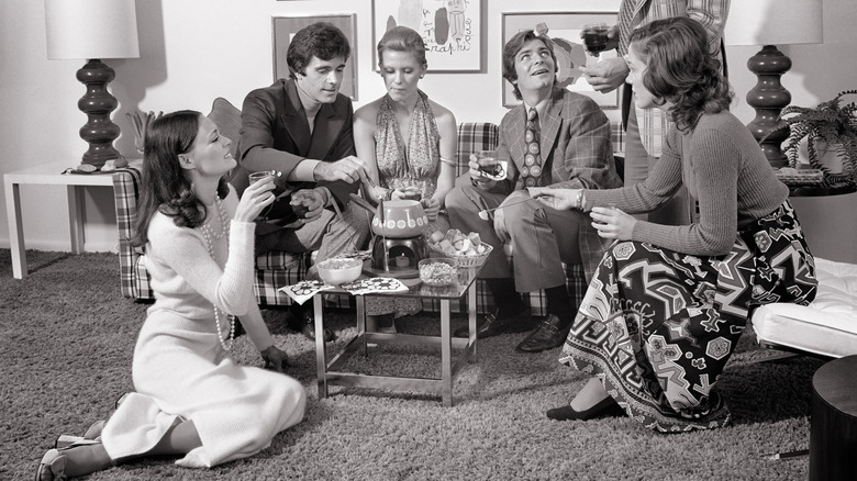 Friends gathered in a home to enjoy fondue