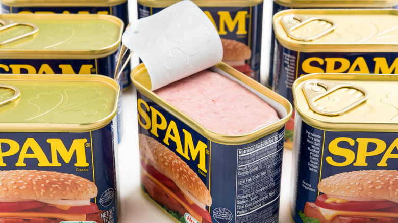 Spam cans in a line, with one opened