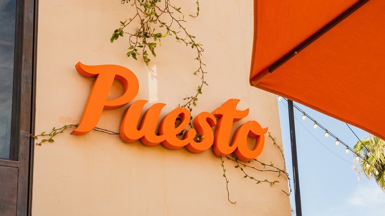 The main sign above Puesto restaurant