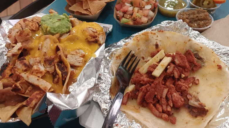 A taco al pastor platter with a side of chips and salsa
