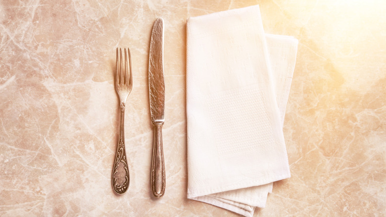 Silverware and napkin on table