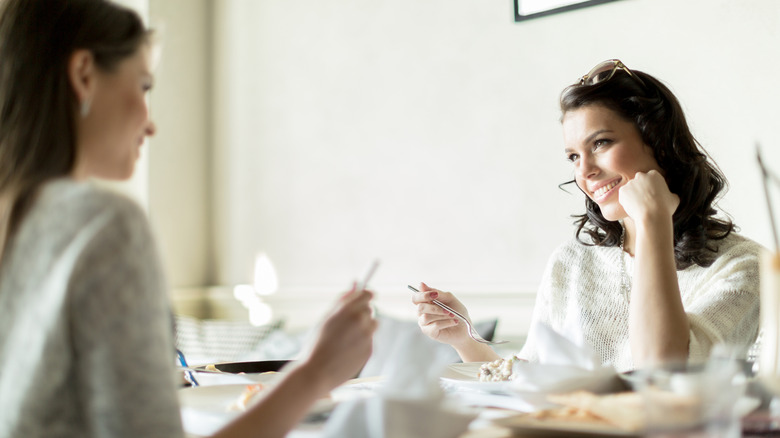 Woman with elbows on table