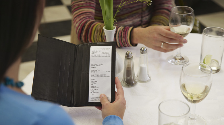 Woman looking at restaurant bill