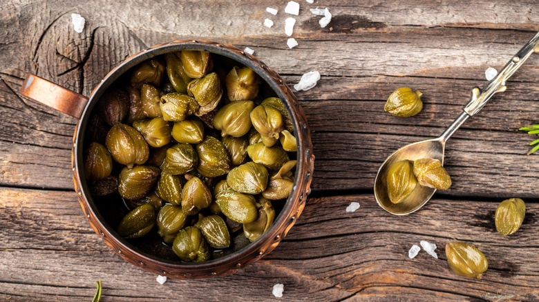 bowl of capers on rustic wooden table