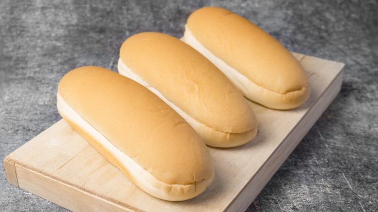 hot dog buns on a wooden board
