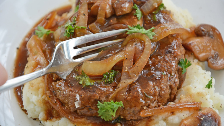 Salisbury steak on top of mashed potatoes