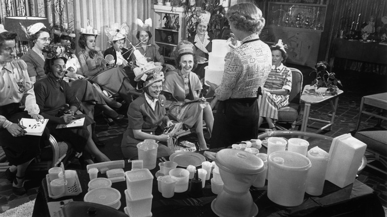 Tupperware party with products on table circa 1950
