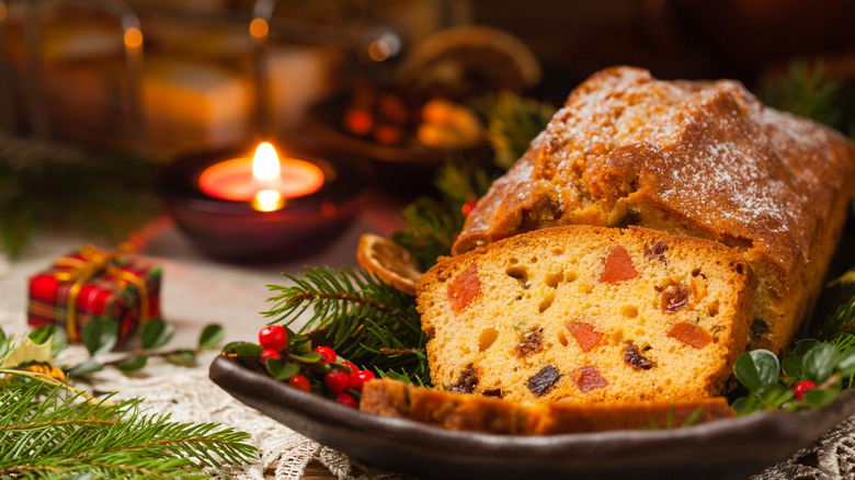 Sliced fruitcake loaf and Christmas decorations