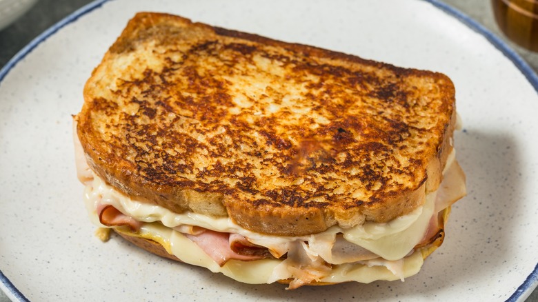 Pan fried Monte Cristo sandwich on white plate