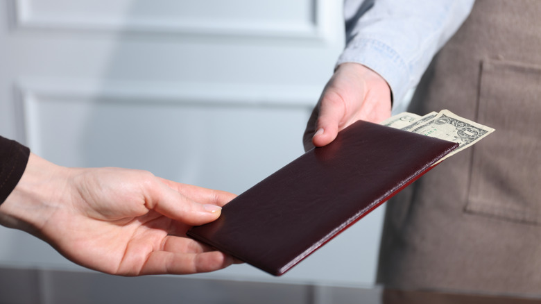 Person paying bill at restaurant
