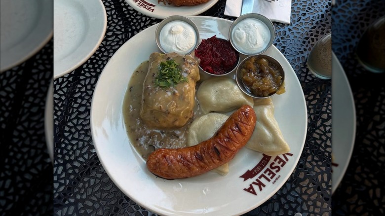 A plate of sausage, pierogies, and stuffed cabbage from Veselka in NYC