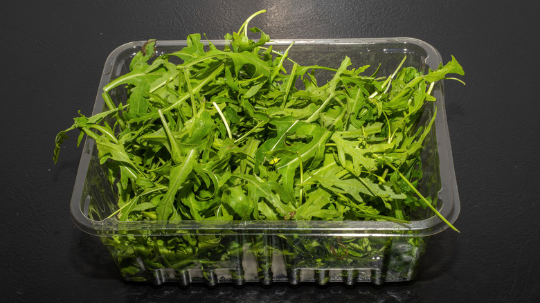 plastic box of arugula