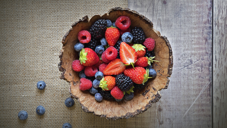 wooden bowl full of berries