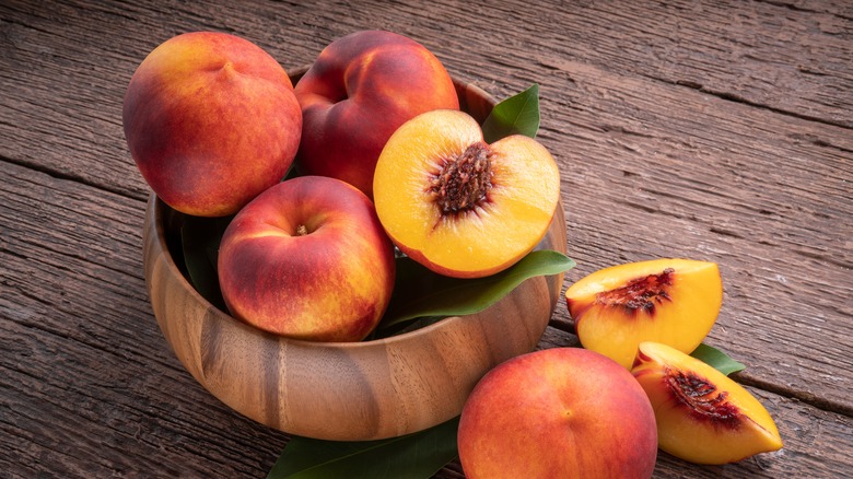 Peaches in wooden bowl