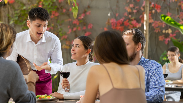 Waiter taking order at restaurant