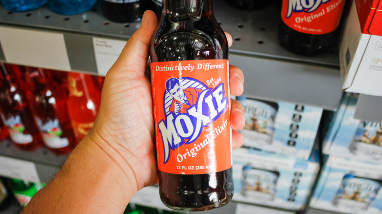 Hand holding Moxie soda