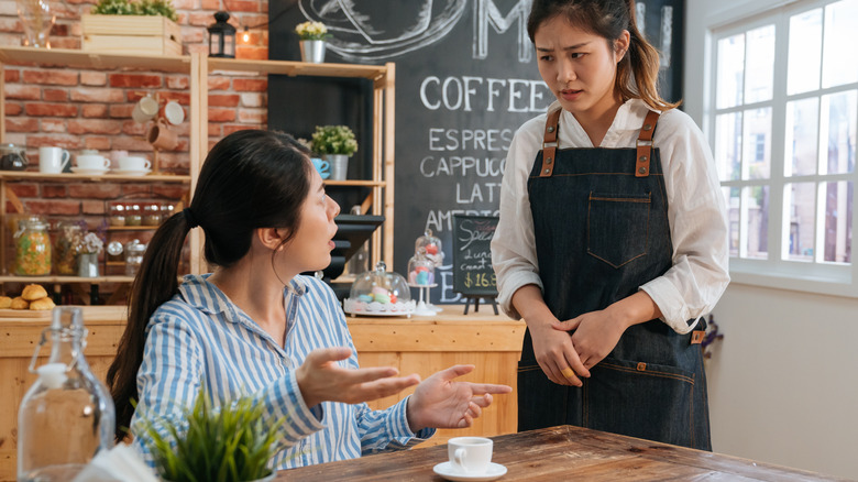 unhappy customer complaining to waitress