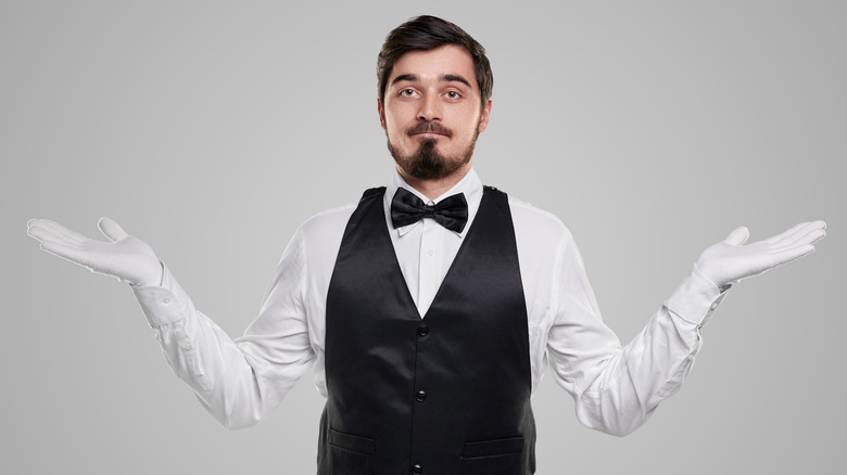 Waiter shrugging in confusion