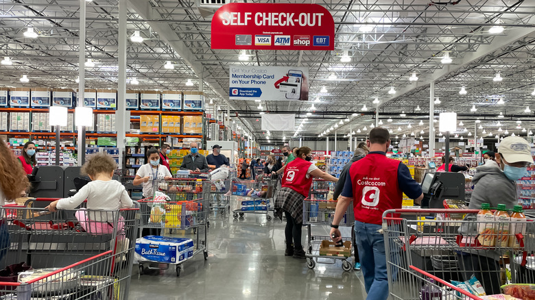 several shoppers and clerks inside Costco