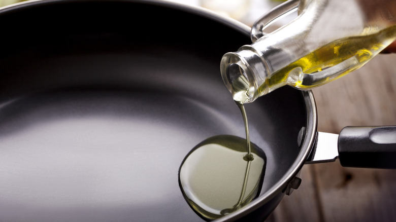 Pouring cooking oil into a pan