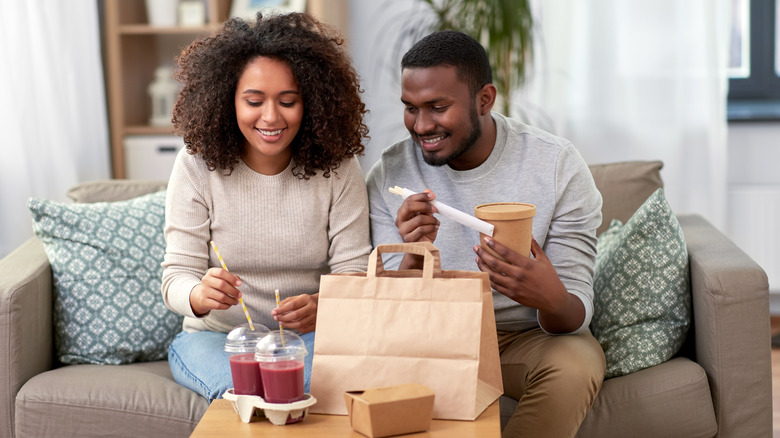 couple eating takeout at home