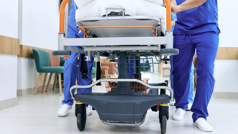 Medical staff pushing a hospital gurney