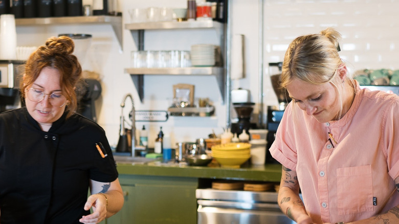 Photo of Kayla Pfeiffer and an assistant in her restaurant Bicyclette Cookshop