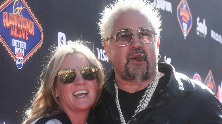 Guy Fieri smoking a cigar with his wife Lori Fieri