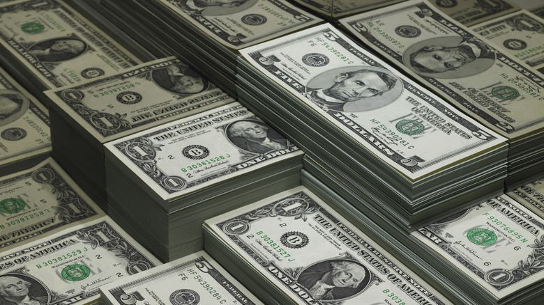 Stacks of cash mostly $1 bills and $5 bills