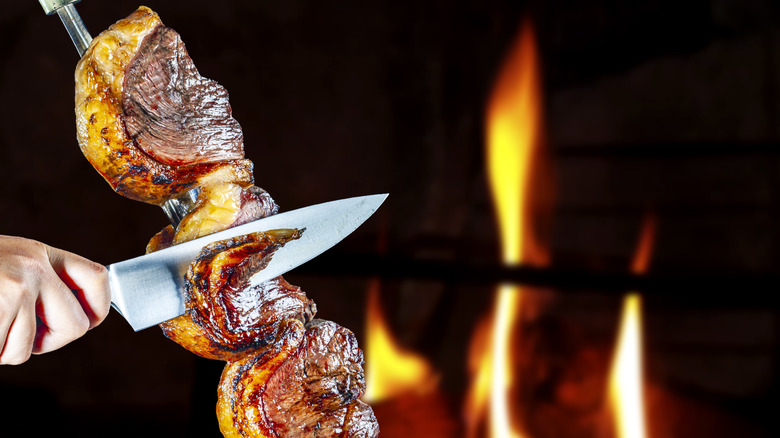 brazilian steakhouse slicing meat