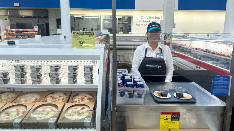 Tastes & Tips employee stands with samples of pizza and Pepsi