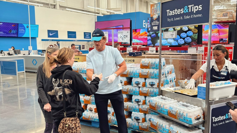 Logan Paul handing out samples of Prime beverages at Sam's Club
