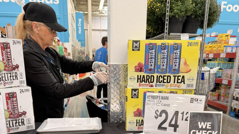 employee pours an alcohol sample inside Sam's Club