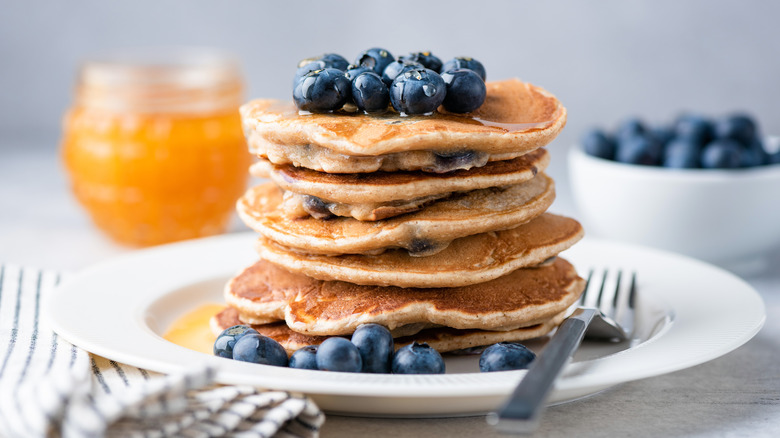 Stack of pancakes topped with blueberries